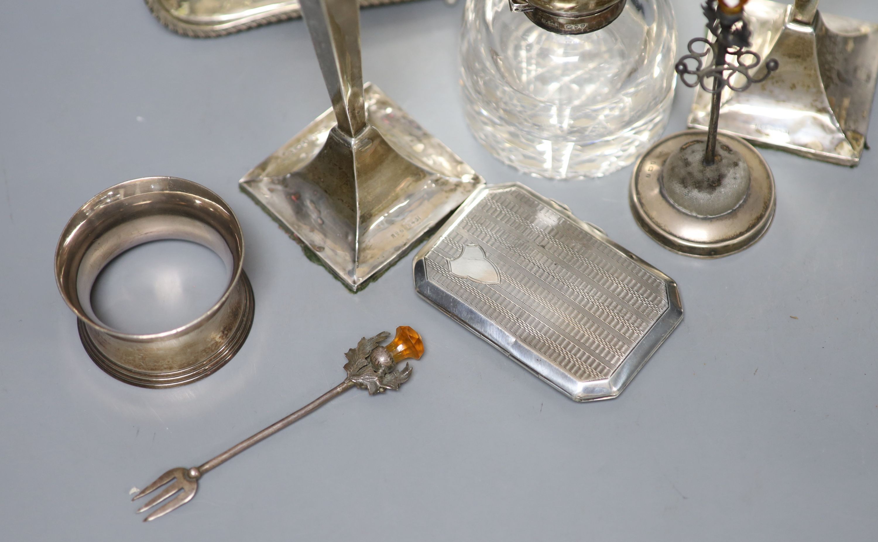 A pair of George V silver candlesticks (a.f.) and other small silver including a hat pin stand, cigarette case and 800 dish etc. and a pair of plated napkin rings.